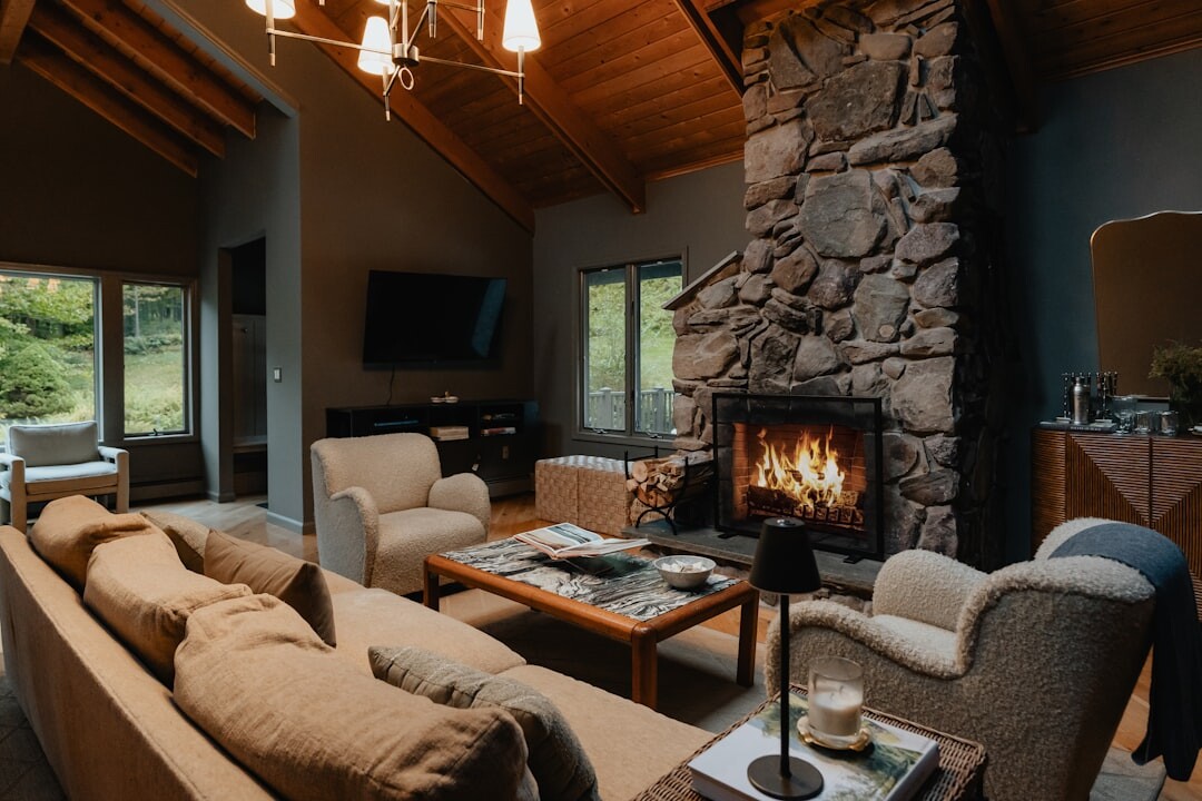 Cozy alpine chalet interior with stone fireplace and wooden beams